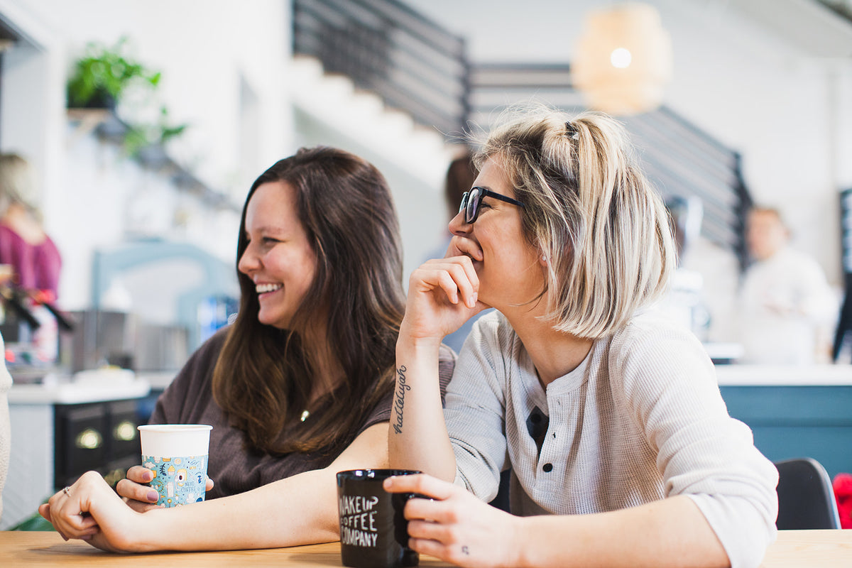 Friends spending time at a Wake Up café patio