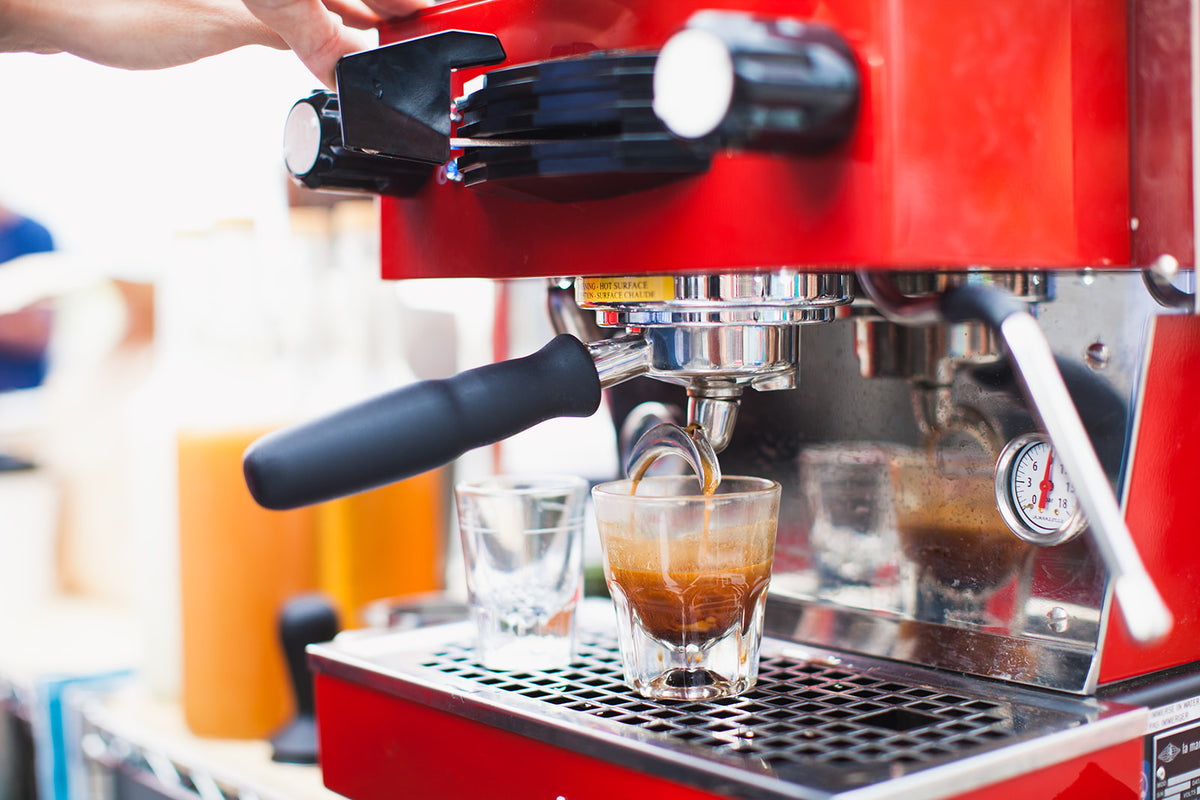 Espresso pouring into a glass at the café
